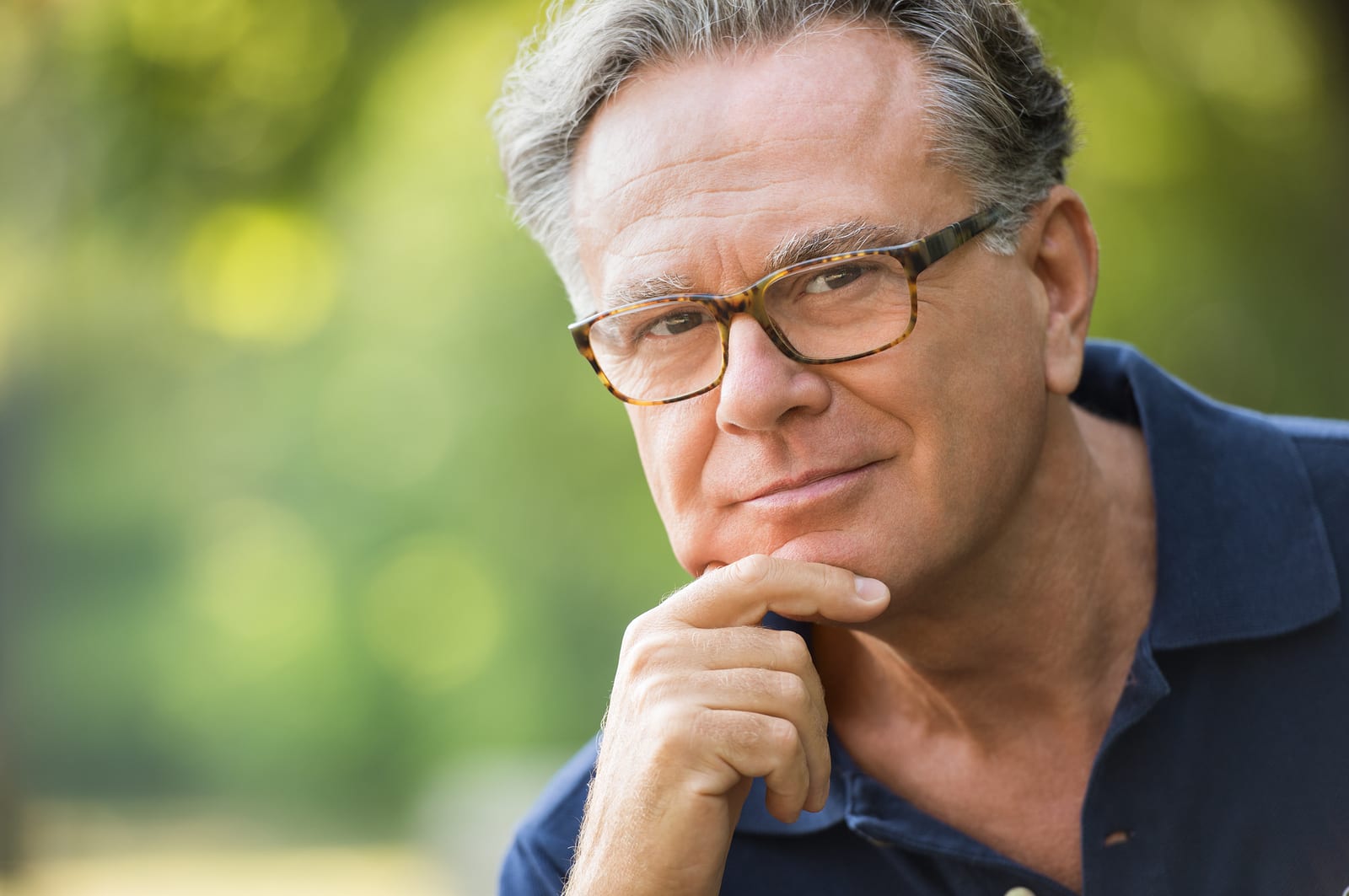 Older man thinking about purchasing hearing aids